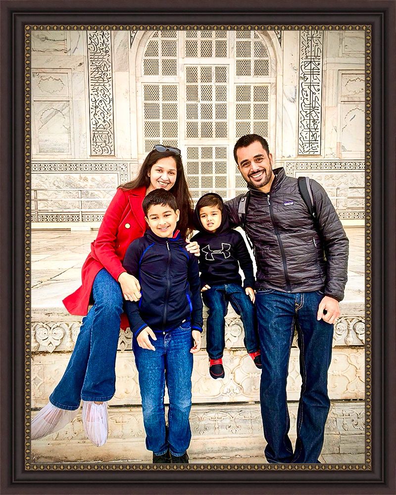 family portrait of parents with two sons at the Taj Mahal